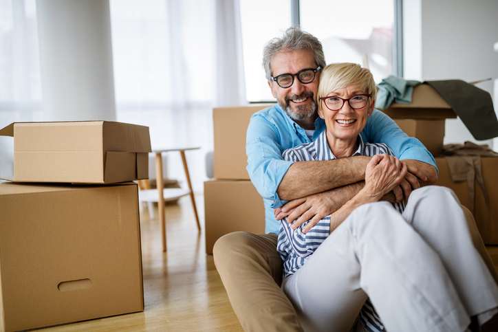 Portrait of happy smiling senior couple in love moving in new home