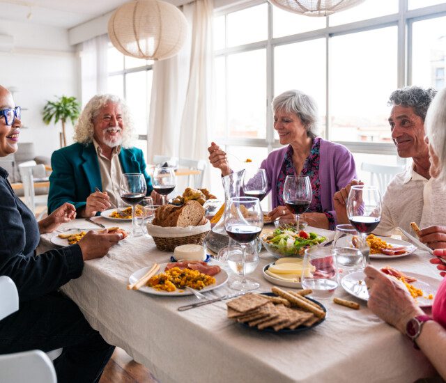 a group of friends enjoying a dinner together in well-appointed settings